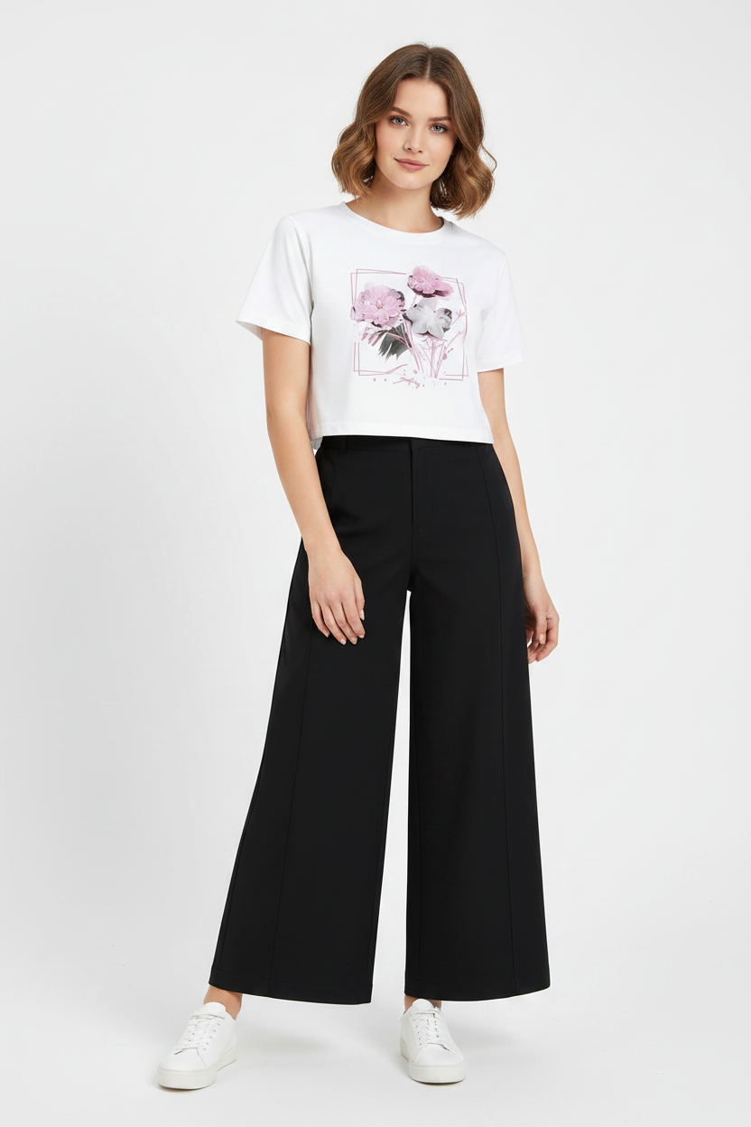 Mannequin wearing a white t-shirt with a graphic design and black wide-leg pants on a white background
